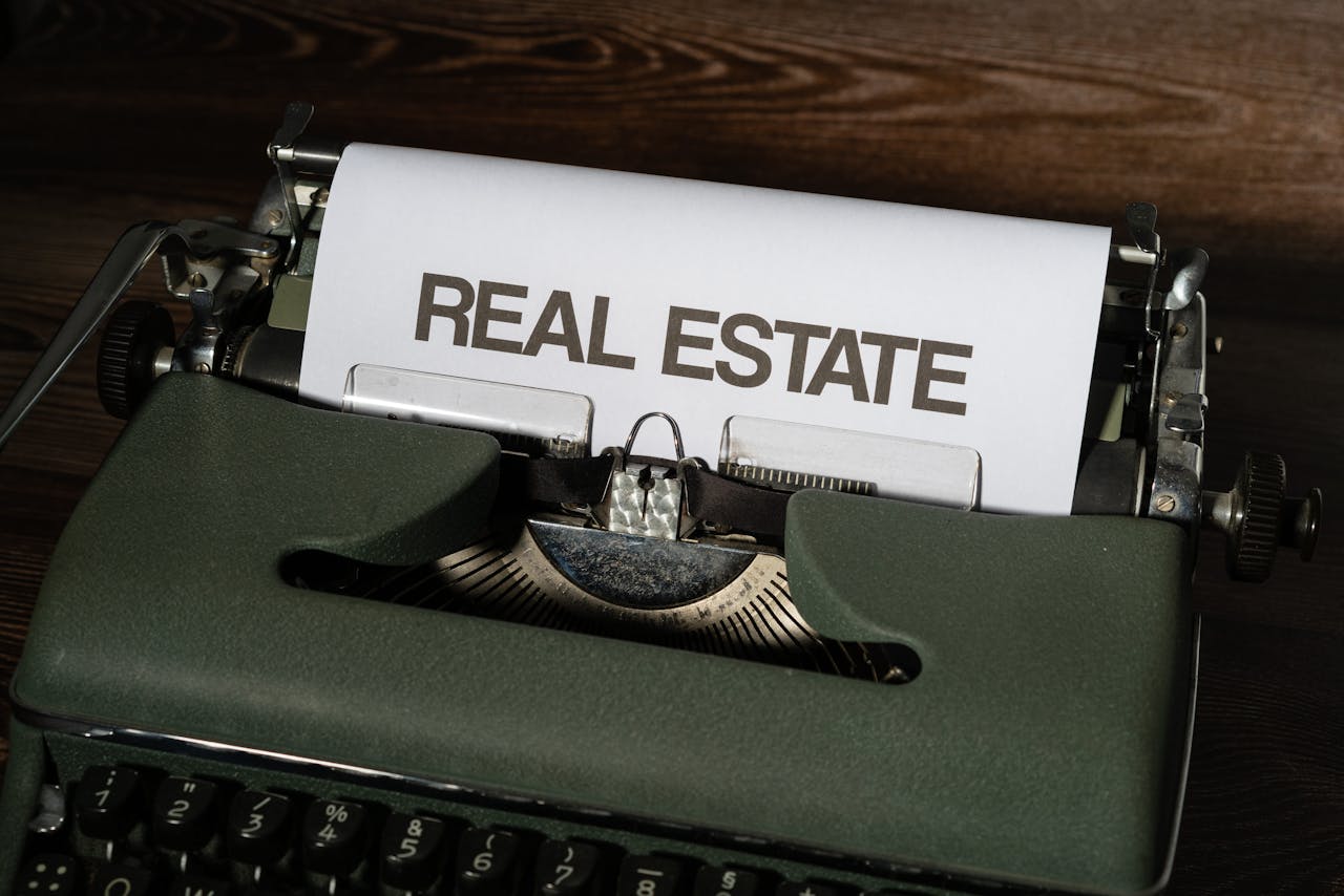 Close-up of a retro typewriter with Real Estate text on paper.